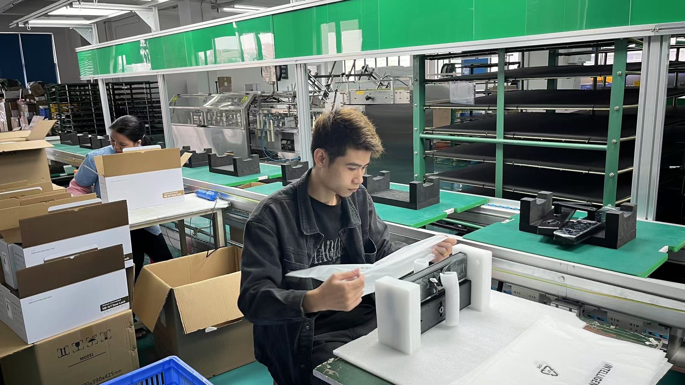 Forty five year old female engineer in laboratory coat, holding technical documents, standing in research lab environment